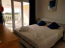 double bedroom with king size bed, door opening on to terrace and with large mirrored wardrobe
